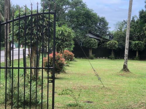 an iron gate in the yard of a house at Hotel Pugoda Village in Pugoda