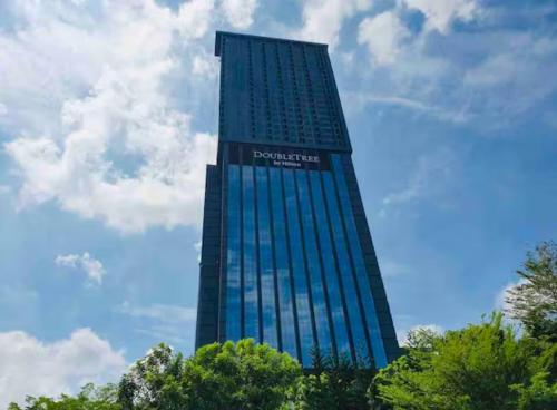 a tall blue building with a sign on it at Sky Pool 4 Star grade stay in i-City in Shah Alam