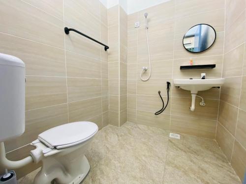 a bathroom with a toilet and a sink at Alyn Home Kluang IV Netflix Wifi Coway in Kluang