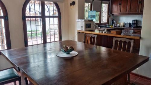 a kitchen with a wooden table with a bowl of fruit on it at El Torreón Lodge in Potrerillos