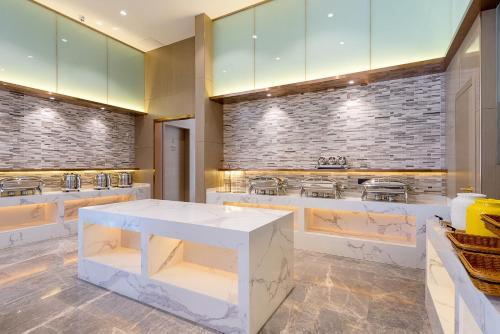 a kitchen with a white counter and a stove at Lavande Hotel Shenzhen Baoan International Convention and Exhibition Center in Shenzhen