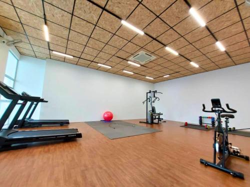 a gym with treadmills and exercise bikes in a room at Bayu Temiang- Your Urban Retreat in Seremban