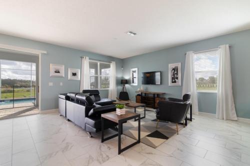 a living room with a couch and chairs and a table at Lovely Pool Home with Spa and Game Room condo in Davenport