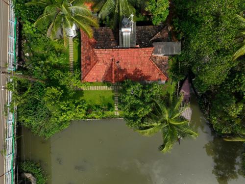 an overhead view of a house with a pond at Little Chembaka in Kumarakom
