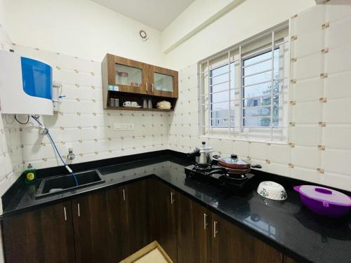 a kitchen with a sink and a counter top at DivBnK homes Bangalore in Bangalore