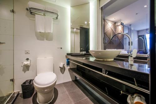 a bathroom with a white toilet and a sink at Spey Hotel - Foshan Ancestral Temple Subway Station in Foshan
