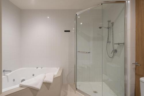 a bathroom with a shower and a bath tub at Ocean View Penthouse in Cowes