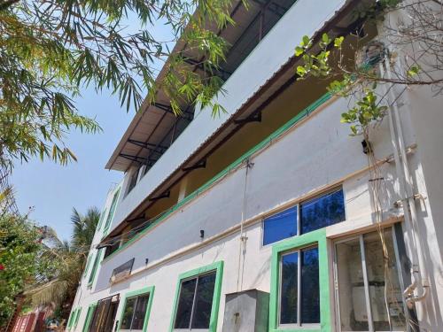 a house with a balcony on top of it at New greens inn in Yelagiri