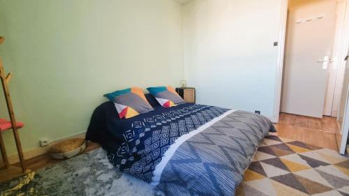 Schlafzimmer mit einem Bett mit blauer Decke in der Unterkunft Appartement entier de 40 m2 proche gare Auterive in Auterive