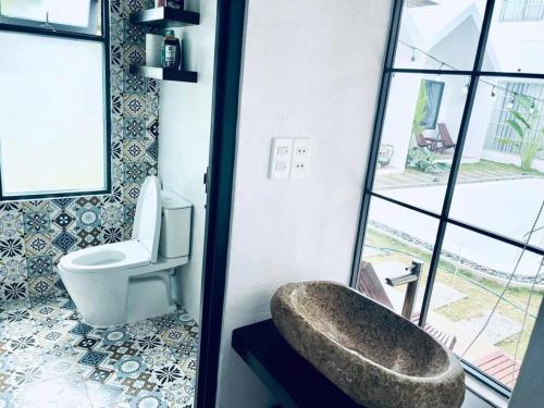 bagno con servizi igienici e ampia finestra. di Villa 3 Room Phan Thiết a Phan Thiet