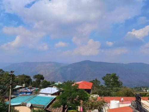 a view of the mountains from a house at Hotel Adinath in Mahabaleshwar