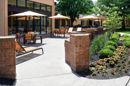a patio with tables and chairs and umbrellas at Courtyard Columbus Dublin in Dublin