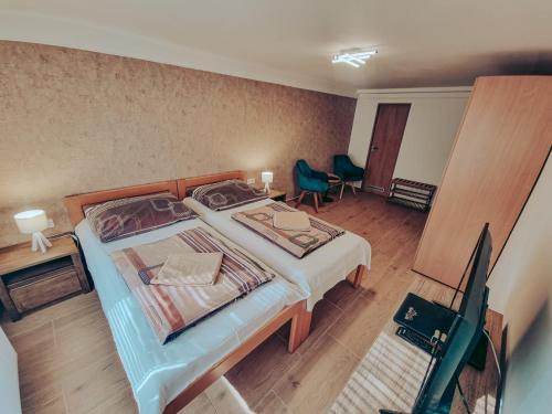 Dormitorio con cama, escritorio y TV en Ubytování u Parku, en Lednice
