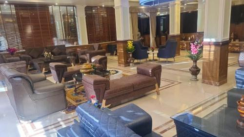 a lobby with couches and chairs in a building at Mentokling Residency, Leh, Ladakh in Leh