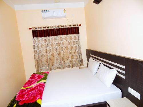 a bedroom with two beds and a window at Hotel PALKI Near Mandarmani Sea Beach in Mandarmoni