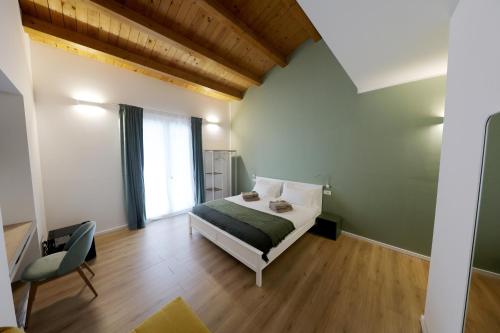 a bedroom with a bed and a chair in it at Argenteria5 Holiday Rooms in Palermo