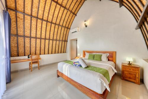 a bedroom with a bed and a large window at Puri Garden Penida in Nusa Penida
