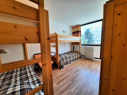 une chambre avec deux lits superposés et une fenêtre dans l'établissement Résidence Belledonne - Appartement 6 pers ski au pied à la Croisette aux Menuires MAE-4714, aux Menuires