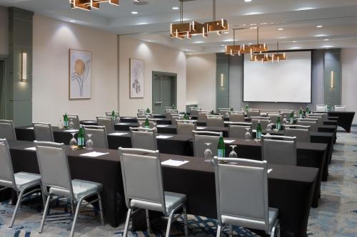 a conference room with a long table and chairs at DoubleTree by Hilton Houston Westchase in Houston