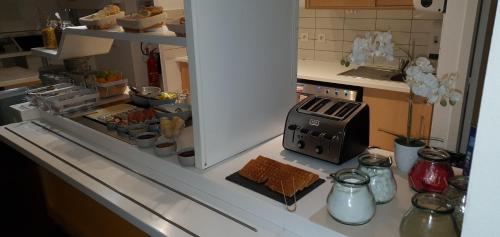 a kitchen counter with a stove with food on it at Ibis Budget Roanne Hôtel in Roanne