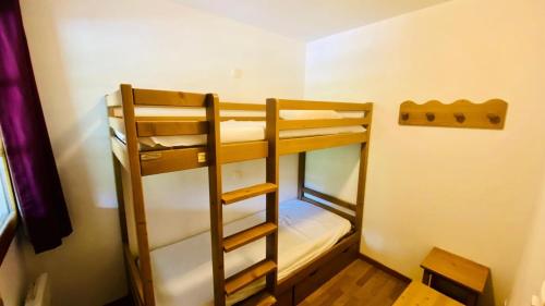 une chambre avec trois lits superposés dans une pièce dans l'établissement Résidence Neige Et Golf - En front de neige pour ce joli studio avec grande terrasse MAE-8614, à Montgenèvre