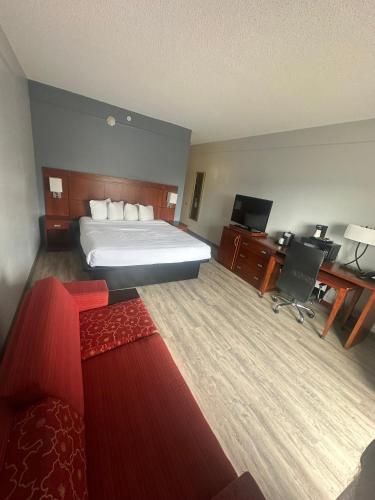 a hotel room with a bed and a desk at Super 8 by Wyndham Dallas Love Field Airport in Dallas