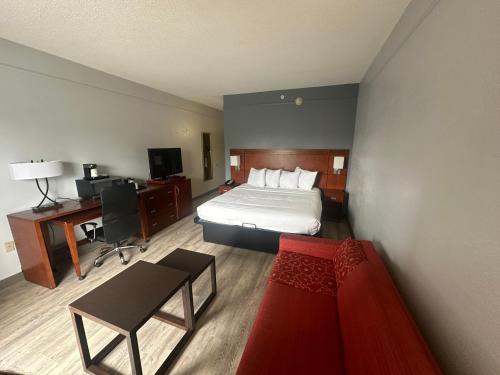 a hotel room with a bed and a desk at Super 8 by Wyndham Dallas Love Field Airport in Dallas
