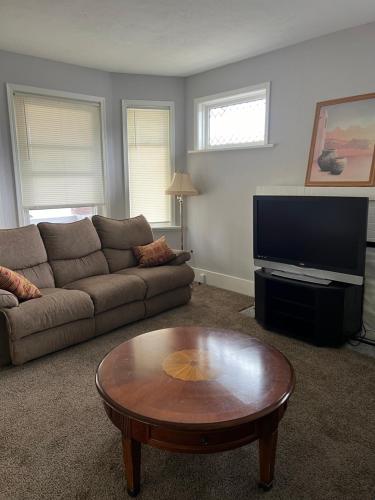 a living room with a couch and a coffee table at House w Separate 4 Private Bedrooms in South Bend