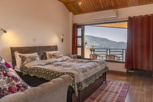 a bedroom with a bed and a large window at 3 Br Harrington Villa Kitchen Living room AC in Kasauli