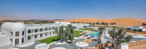 an aerial view of a building in the desert at Western Hotel Liwa in Liwa