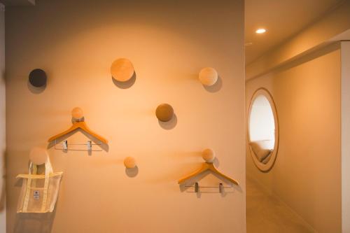 a bathroom with a wall with hangers and a mirror at TheMana Village in Tosashimizu