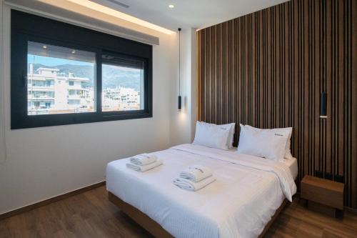 a bedroom with a bed with two towels on it at Volos Inn Hotel in Volos