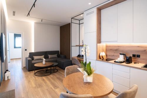 a living room with a couch and a table at Volos Inn Hotel in Volos