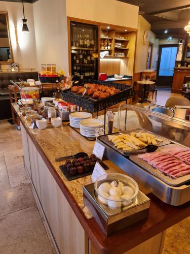 Una línea de buffet con muchos tipos diferentes de comida. en Domaine de Larchey, en Saint-Médard-dʼEyrans