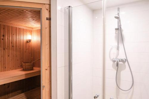 a shower with a glass door in a bathroom at Résidence Gaia - Chalets pour 8 Personnes 764 in Chamonix