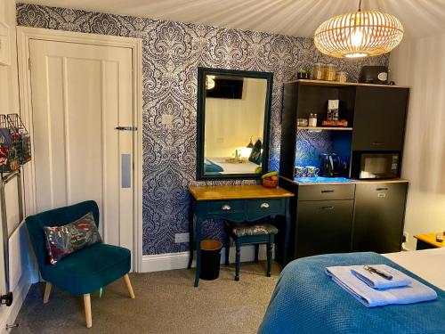 a bedroom with a blue sink and a mirror at The Sapling in Delabole