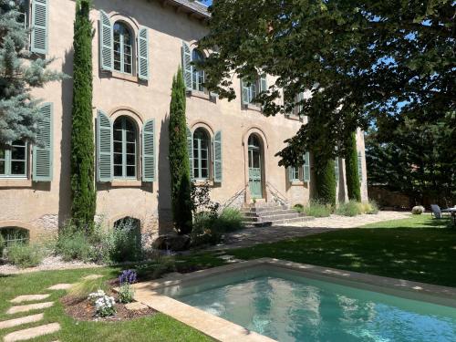 a house with a swimming pool in the yard at Couvent de la Salette & Spa in Millau