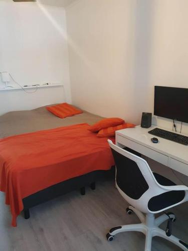 Schlafzimmer mit einem Bett und einem Schreibtisch mit einem Computer in der Unterkunft Yksiö luonnonläheisyydessä in Seinäjoki