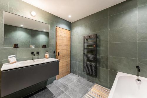 a bathroom with a sink and a mirror at Résidence Blom - Chalets pour 12 Personnes 634 in Saint-Martin-de-Belleville
