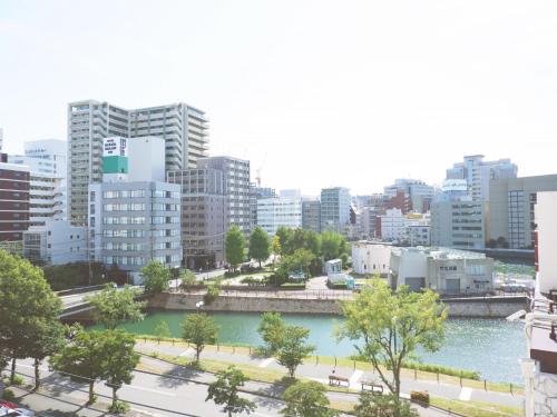 a view of a city with a river and buildings at DD HOTEL 中洲 in Fukuoka