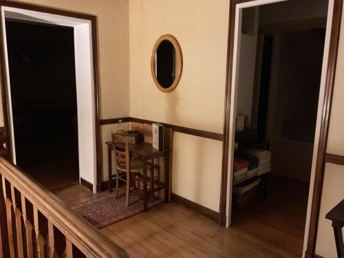 a room with a table and a mirror on the wall at Atelier chez Marie in Carnetin