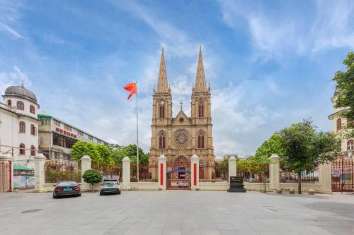 a church with two towers and a red flag at 逸方里广州北京路海珠广场地铁站店 in Guangzhou