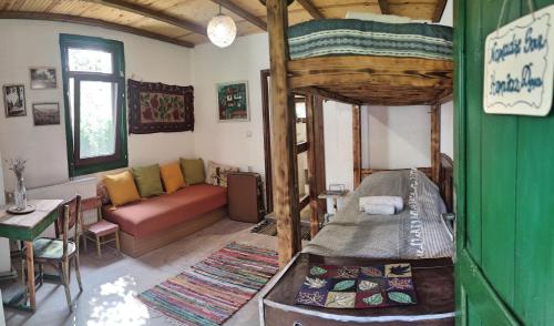 a living room with a bed and a couch at ZeLLin House of Inspiration in Botevgrad