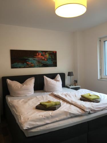 a bedroom with a large bed with two pillows on it at Ferienwohnung Bodensee Nenzingen Hegau in Orsingen-Nenzingen