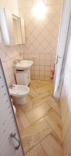 a bathroom with a toilet and a sink at La casa di Cry in Cagliari