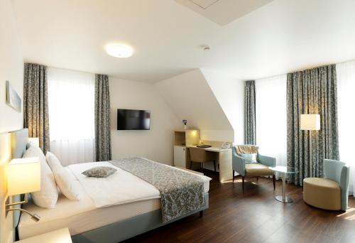 a hotel room with a bed and a desk at Schlosshotel Ingelfingen in Ingelfingen