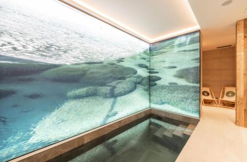 an indoor swimming pool with an ocean view in a bathroom at Résidence Bois Du Fontanil - Chalets pour 12 Personnes 474 in le Praz