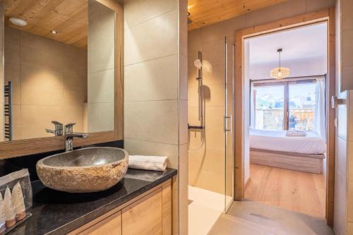 a bathroom with a sink and a glass shower at Résidence Les Gentianes - Pièces 394 in LʼHuez