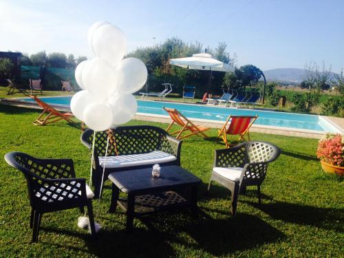 a group of chairs and a table with balloons at Casale Papa Country Village in Loreto