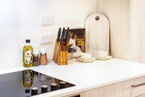 a kitchen counter with a knife block and a board at Urban Gem in the CBD Studio in Christchurch